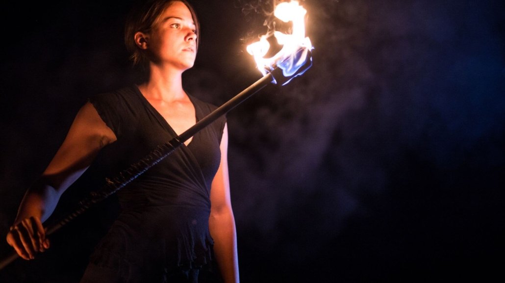 victim to warrior woman with flaming torch representing warrior woman in victim or warrior