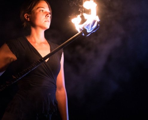 woman with flaming torch representing warrior woman in victim or warrior