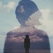Woman's silhouette dissolving into clouds - visual metaphor for losing yourself in relationships through self-erasure and accommodation