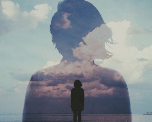 Woman's silhouette dissolving into clouds - visual metaphor for losing yourself in relationships through self-erasure and accommodation