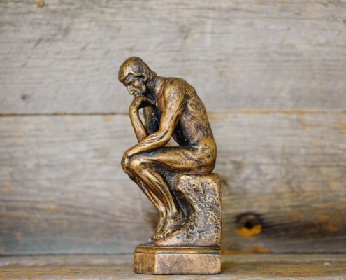 a statue thinking depicting AI and human identity