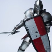 knight wearing full armor and holding a shield showing defensiveness