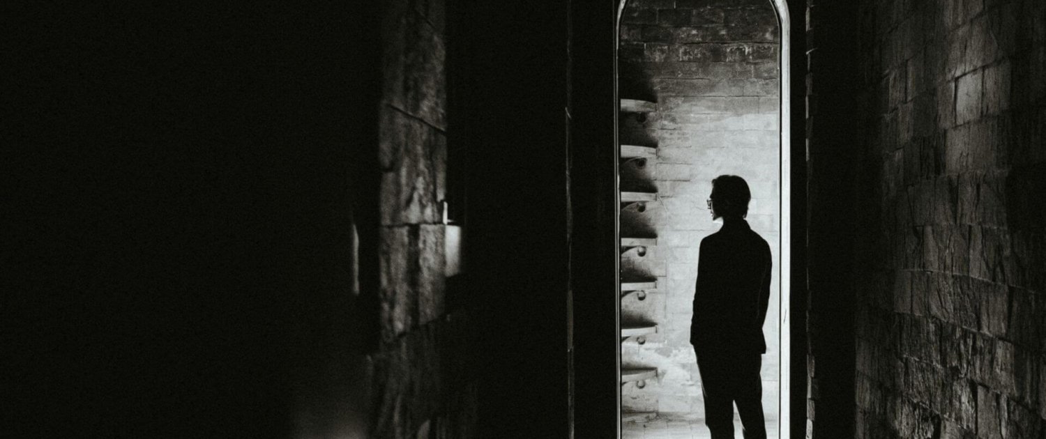 person standing at the threshold of identity transformation