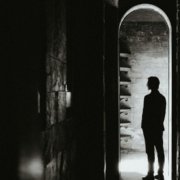 person standing at the threshold of identity transformation