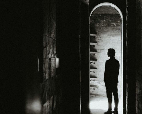 person standing at the threshold of identity transformation