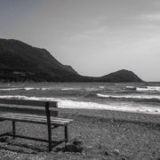 empty bench by the sea depicting loneliness